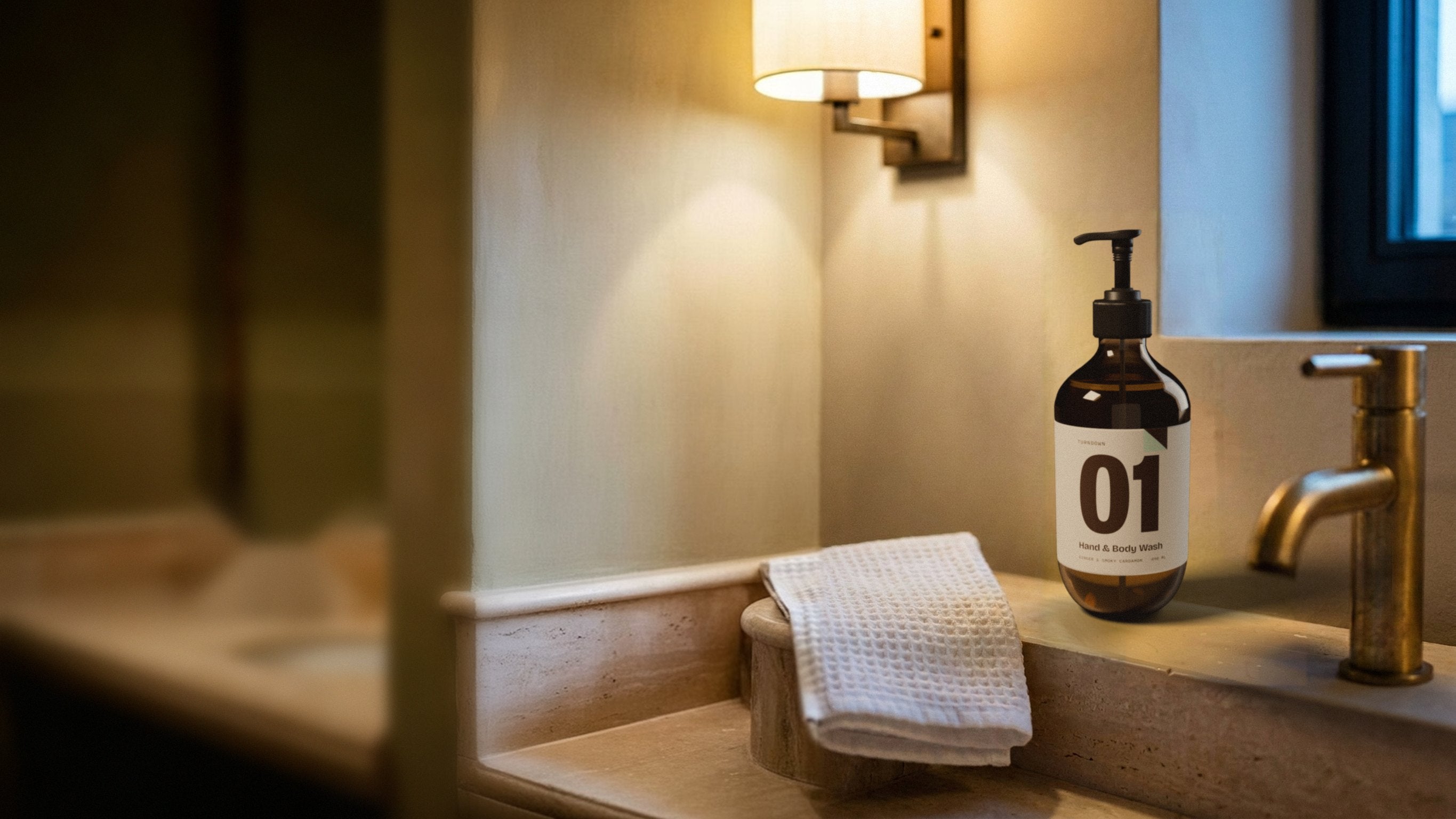 TURNDOWN No. 01 on a travertine hotel sink in the evening